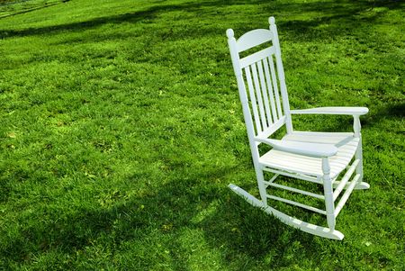White rocking chair on the lawn.の写真素材