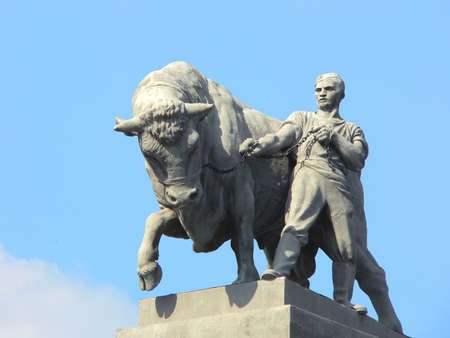 Statue of the worker of the bull, holding on a circuitの写真素材