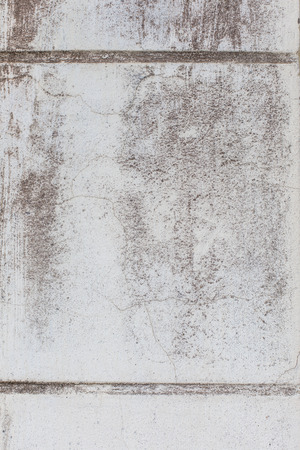 Old wall covered with lime whitewash fragment as a background grunge textureの写真素材