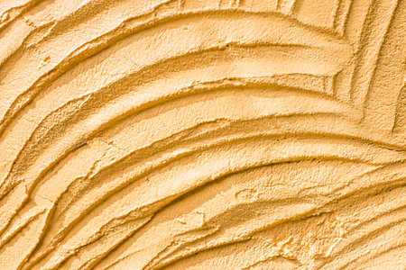 Background of concrete texture decorative surface on wall yellow colorの写真素材