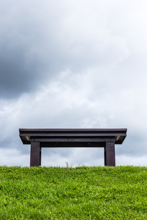 chair on a meadow with green grass and blue skyの写真素材