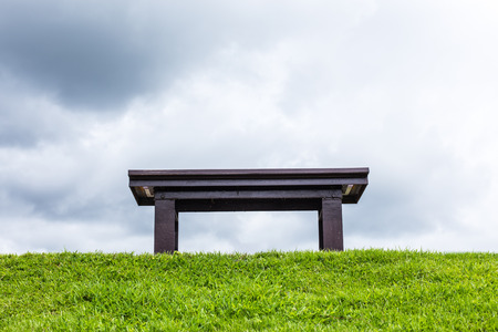 chair on a meadow with green grass and blue skyの写真素材