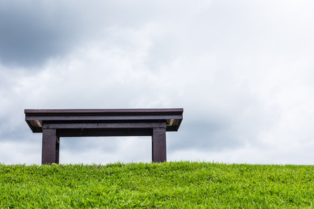 chair on a meadow with green grass and blue skyの写真素材
