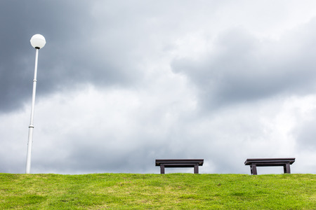 two chair on a meadow with green grass and blue skyの写真素材