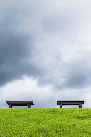 chair on a meadow with green grass and blue skyの写真素材