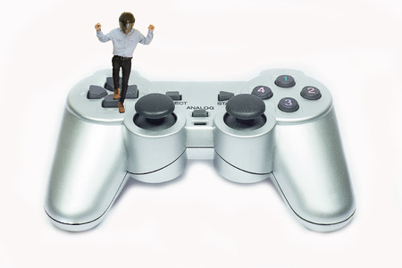 Small man plays video game with joystick.の写真素材