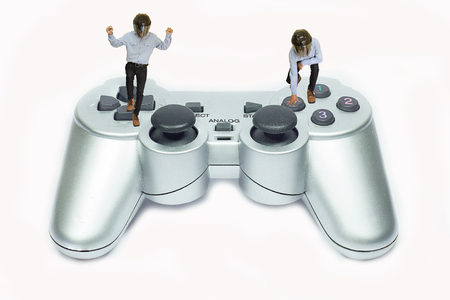 Small man plays video game with joystick.の写真素材