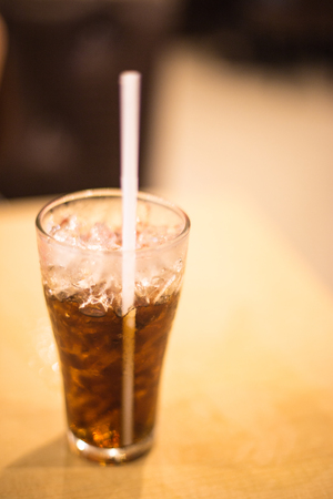Fresh black soda with ice on wood table.の写真素材