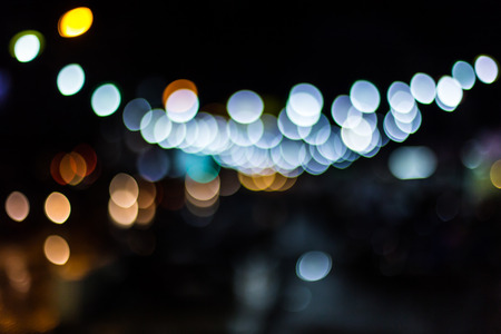 Blurred Defocused Lights of Heavy Traffic on a Wet Rainy City Road at Night .の写真素材