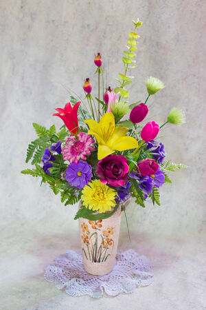 still life bogus flowers on painting background selected focus.の写真素材
