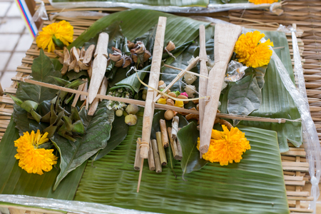 Traditional balinese offerings to gods in Bali with flowers and aromatic sticks.の写真素材