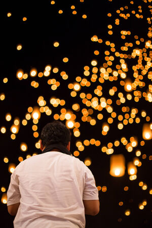 Photographer taking photo with DSLR camera at lantern festival nightの写真素材