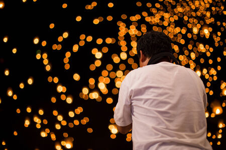 Photographer taking photo with DSLR camera at lantern festival nightの写真素材