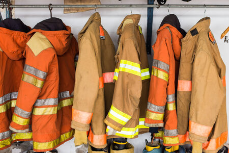 Yellow helmet and jacket of fire fighter.の写真素材
