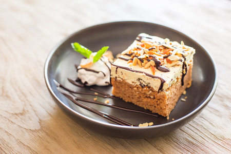 carrot cake with walnuts, prunes and dried apricots on a dark wood background. tinting. selective focusの写真素材