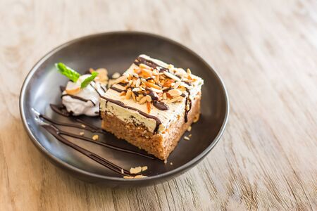 carrot cake with walnuts, prunes and dried apricots on a dark wood background. tinting. selective focusの写真素材