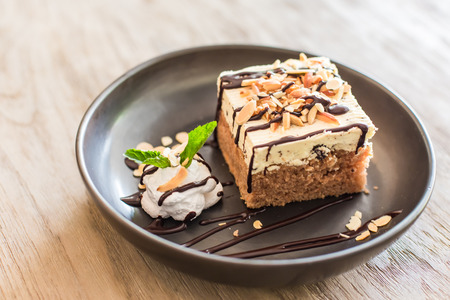 carrot cake with walnuts, prunes and dried apricots on a dark wood background. tinting. selective focusの写真素材