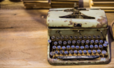 A blur background Vintage Typewriter on a wooden tableの写真素材