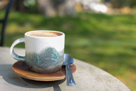 cup coffee and sunny trees background.の写真素材