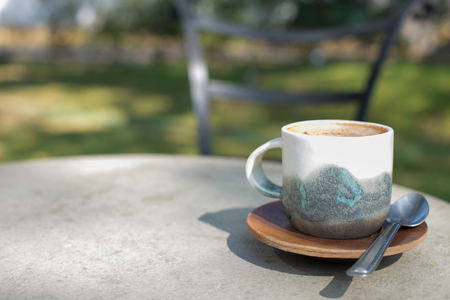 cup coffee and sunny trees background.の写真素材