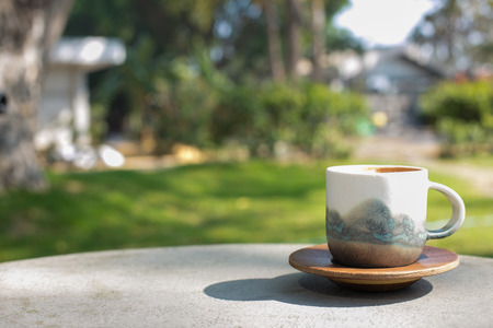 cup coffee and sunny trees background.の写真素材