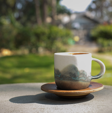 cup coffee and sunny trees background.の写真素材