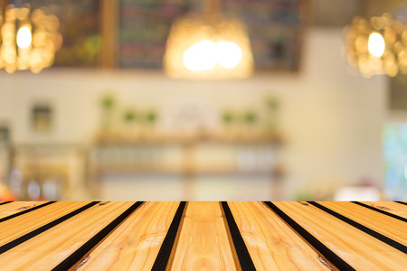 Selected focus empty brown wooden table and Coffee shop blur background with bokeh imageの写真素材