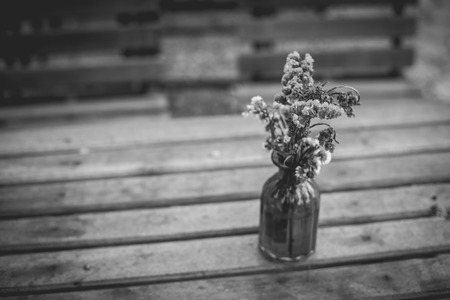 Lavender flowers in glass vase in vintage tone on wooden table.の写真素材