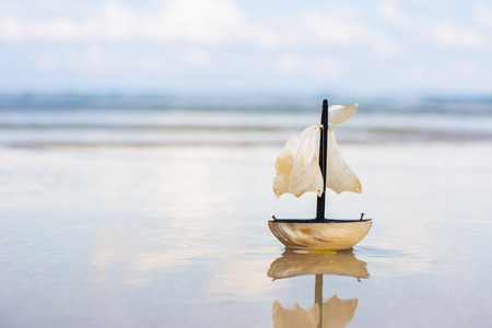 toy sail boat at the beach.の写真素材