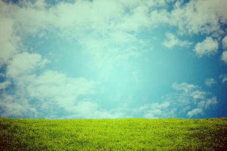 green grass and sky, vintage retro style.の写真素材