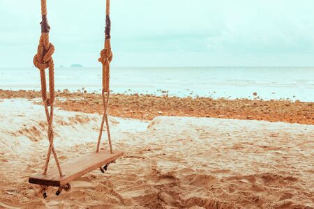 Wooden swing in tropical beach in Thailand. Vintage filter.の写真素材