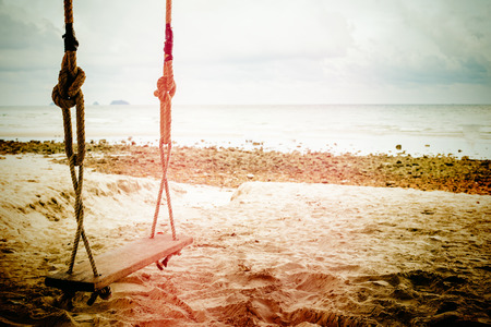 Wooden swing in tropical beach in Thailand. Vintage filter.の写真素材