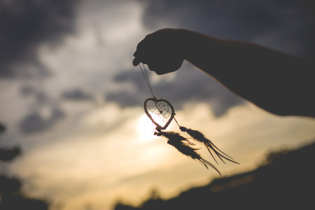 Silhouette of hand with dream catcher vintage and retro tone, soft focusの写真素材