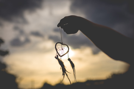 Silhouette of hand with dream catcher vintage and retro tone, soft focusの写真素材