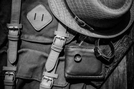 still life photography : Brown leather wallet, Leather wristbands, silver ring and adventure hat on jeans background, men casual concept, vintage and retro styleの写真素材