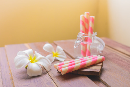 Wafer roll sticks glass bottle and wooden tableの写真素材