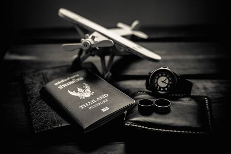 Thailand passport and traveler set on wood background, vintage and retro style.の写真素材