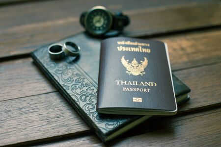 Thailand passport and traveler set on wood background, vintage and retro style.の写真素材