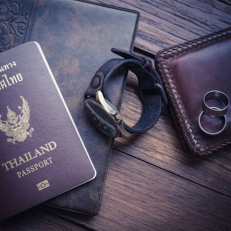 Thailand passport and traveler set on wood background, vintage and retro style.の写真素材