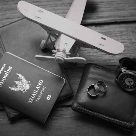 Thailand passport and traveler set on wood background, vintage and retro style.の写真素材