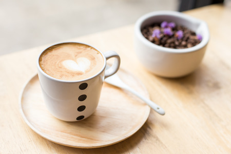 Art Latte Coffee in a cup on wooden table.の写真素材
