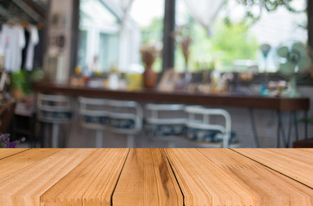 Selected focus empty brown wooden table and Coffee shop blur background with bokeh image, for...