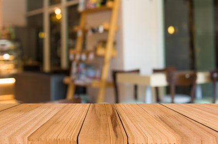 Selected focus empty brown wooden table and Coffee shop blur background with bokeh image.の写真素材