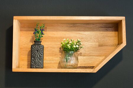 flowers arranged in the corner of a wooden box.の写真素材