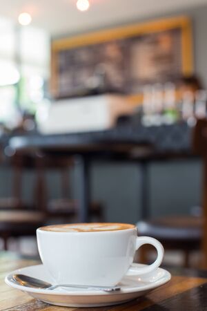 Hot art Latte Coffee in a cup on wooden table.の写真素材