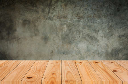 Wooden table with cement background.の写真素材