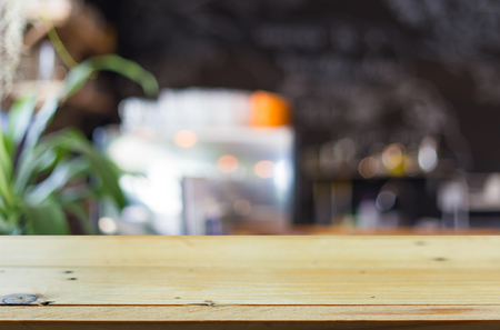 Selected focus empty brown wooden table and Coffee shop blur background with bokeh image, for product display montage.の写真素材