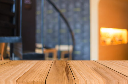 Selected focus empty brown wooden table and Coffee shop blur background with bokeh image, for...