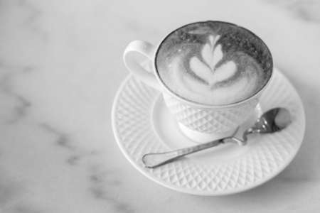 Hot art Latte Coffee in a cup on wooden table.の写真素材