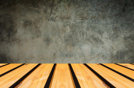 Wooden table with cement background.の写真素材